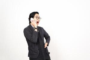 A man in glasses and a suit talking on a cell phone photo
