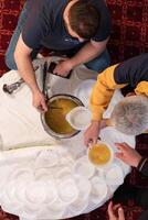 Top view of people serving food at a Mosque a communal meal during Ramadan before breaking the fast on Iftar dinner. Warm festive atmosphere celebrating Ramadan Karim and Eid, the Islamic holy month photo