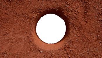 top view of a hole in red ground, exposed soil cavity, circular pit in textured dirt, excavation site, eroded terrain, isolated background png