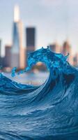 A wave breaking on the water with a city in the background photo