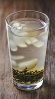 A glass of green tea with ice and ice cubes photo
