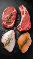 Set of meat fish steak veal steak and chicken breast top view on a black stone background photo