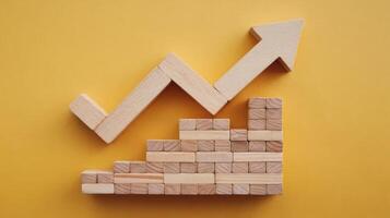 Wooden blocks with an upward arrow on a yellow background photo