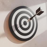 An arrow is hitting a target in a dartboard photo