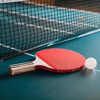 Table tennis racket and ball on a table photo