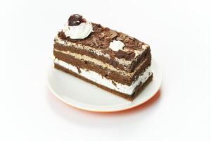 A piece of cake on a plate with a cherry on top photo