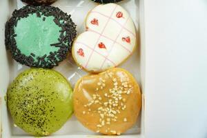 A box of donuts with different designs photo