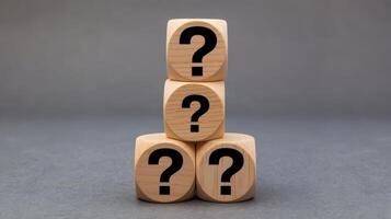 Wooden blocks with question marks on them photo
