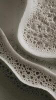 A close up of a foam that is on top of a surface photo