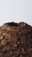 A dirt mound with rocks and dirt on top photo