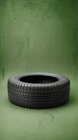 Black and white rounded tire shaped product display pedestal on green background photo