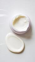Face or body white cream drop or swipe hr balm lotion isolated on white background photo