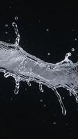 Water splashes isolated on black background white jets with drops photo