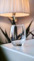 A glass bowl sitting on a table next to a lamp photo