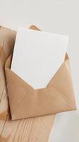 An envelope with blank paper on top of a wooden table photo