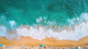 Aerial view of crowded beach, turquoise water, waves, summer vacation photo