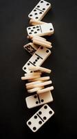 Falling domino chips on a black background photo