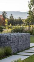 A garden with a stone wall and grass photo