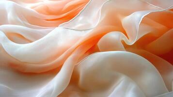 Peach and cream silk fabric drapes, soft folds, light background, textile texture photo