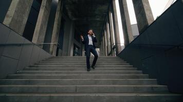 Full-length view businessman talking business call talk mobile phone outside walking stairs down stairway leave office building negotiate distant man male guy employer answer speaking smartphone going photo