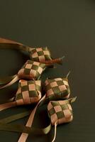 a group of four small squares with ribbons tied to them photo