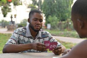 friends playing card together, having fun photo