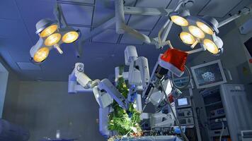 Surgical room with innovative equipment for neurosurgical operations. Robotic arms decorate new year tree with snowflake on the operating table. video
