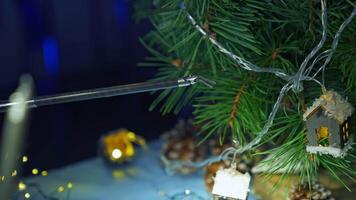 Robotic arm adjusting Christmas decoration on the pine-tree. Little claw dealing with delicate work. Close up. video