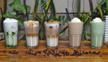 Coffee beverages with coffee beans on the wooden table in coffee shop photo