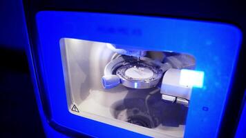 Advanced automated dental milling machine. Dental milling machine carving out shape of human teeth video