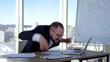 Businessman sitting at office desk. Angry worker looking at computer monitor during working day in office video