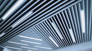 White ceiling with lighting in room. Ceiling lights custom designed for an office business building video
