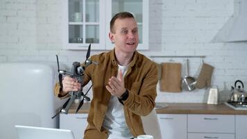Man at home with drone. Young man playing with drone at home video