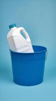 A blue bucket with a white jug in it photo
