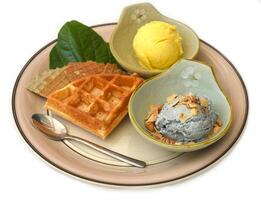 Two scoops of organic ice cream with Belgium waffle isolated on white background photo