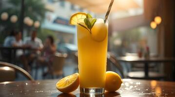 A glass of lemonade with a slice of lemon on the table photo