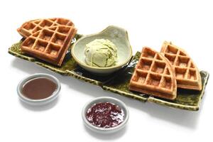 Homemade ice cream with waffle on plate with chocolate syrup and marmalade photo