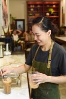 Vietnamese barista added ice and straw in vietnamese coffee Cafe Sua photo