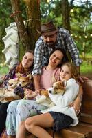 Family members father, mother and two daughters with dogs in the forest photo