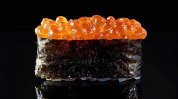 Sushi with a layer of rich, shiny fish roe sits elegantly on a sleek black surface, reflecting the delicate craftsmanship of Japanese culinary traditions. photo