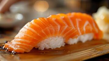 Delicate pieces of salmon sushi are arranged artfully on a bamboo platter, highlighting the vivid orange color of the fish against the white rice, creating an inviting culinary experience. photo