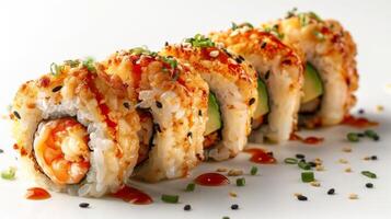Freshly made sushi rolls are perfectly lined up on a white plate, featuring shrimp and avocado, topped with spicy sauce and garnished with green onions and sesame seeds for added flavor. photo