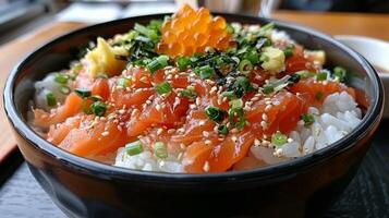 A nourishing bowl filled with tender slices of salmon sashimi over fluffy white rice, garnished with green onions, sesame seeds, and a hint of yuzu, all enjoyed during a lunch outing in Japan. photo