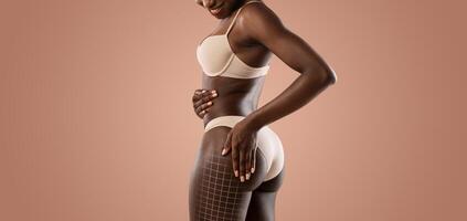 African American woman engages in body sculpting and contouring, emphasizing her curves and wellness. The soft lighting creates a calming atmosphere ideal for skin care and feminine empowerment. photo