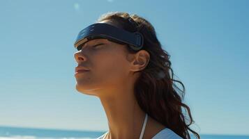 A woman enjoys a moment of tranquility at the beach, closing her eyes and wearing a sleek headband designed for relaxation, with waves gently crashing in the background. photo