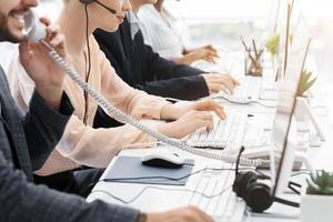 Closeup view of customer support operators working at call centre, copy space. Panorama photo