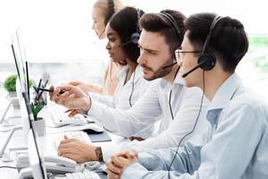 Technical support operators solving problem with client communication at call centre photo