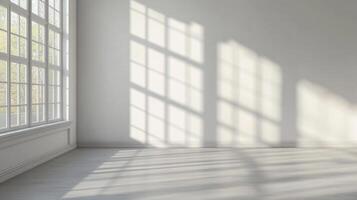 Bright minimalist interior with sunlight streaming through a large window, casting shadows on the wall and floor. Empty room with natural light. photo