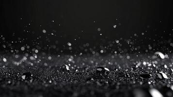 An enchanting image of droplets glistening on a sleek black surface, creating a captivating visual experience that evokes feelings of mystery and allure in a modern aesthetic. photo