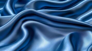 An exquisite view of blue satin fabric flowing gracefully, portraying elegance and luxury, embodying richness and smooth textures in an artistic representation. photo